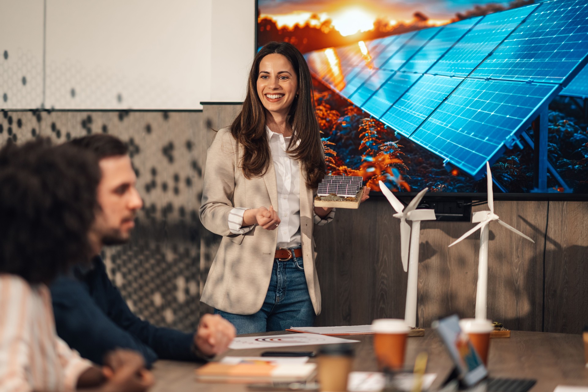 Businesswoman with solar panels model having presentation at office.